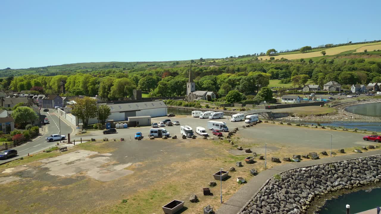 Aerial video of the boats parked at Glenarm Bay, on the Causeway Coastal Route in Northern Ireland, on a bright and sunny day. Filmed in 4K, 60FPS and with Rec709 color.