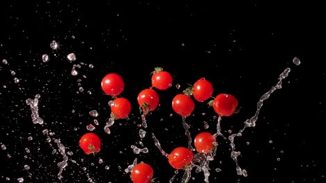 water splashing cherry tomatoes