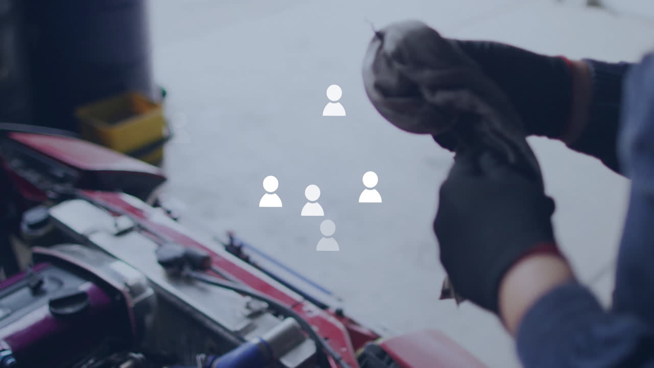 Mechanic cleaning hands with cloth over car engine and people icons animation