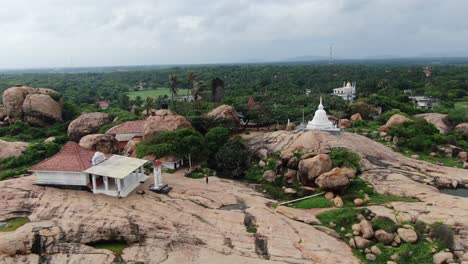 White-stupa-temple-on-top-of-rock-on-the-coastline-of-Kirinda-in-Sri-Lanka-revealing-ocean-in-background