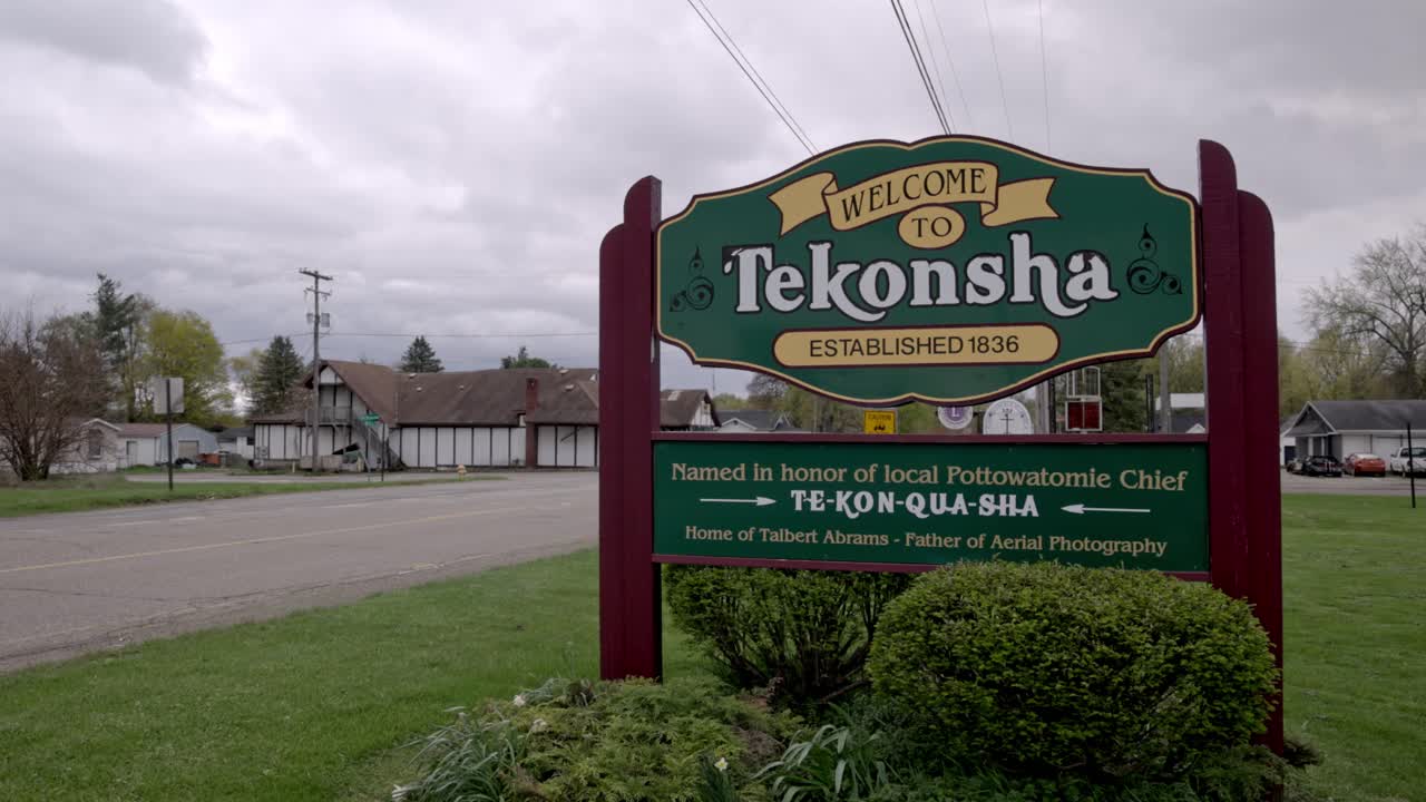 Welcome to Tekonsha, Michigan sign with gimbal video stable and truck driving by