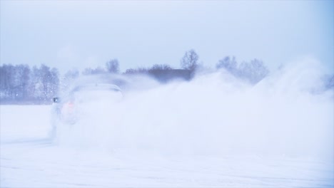 car drifting in snowy landscape