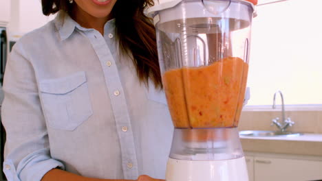 pretty woman making a smoothie