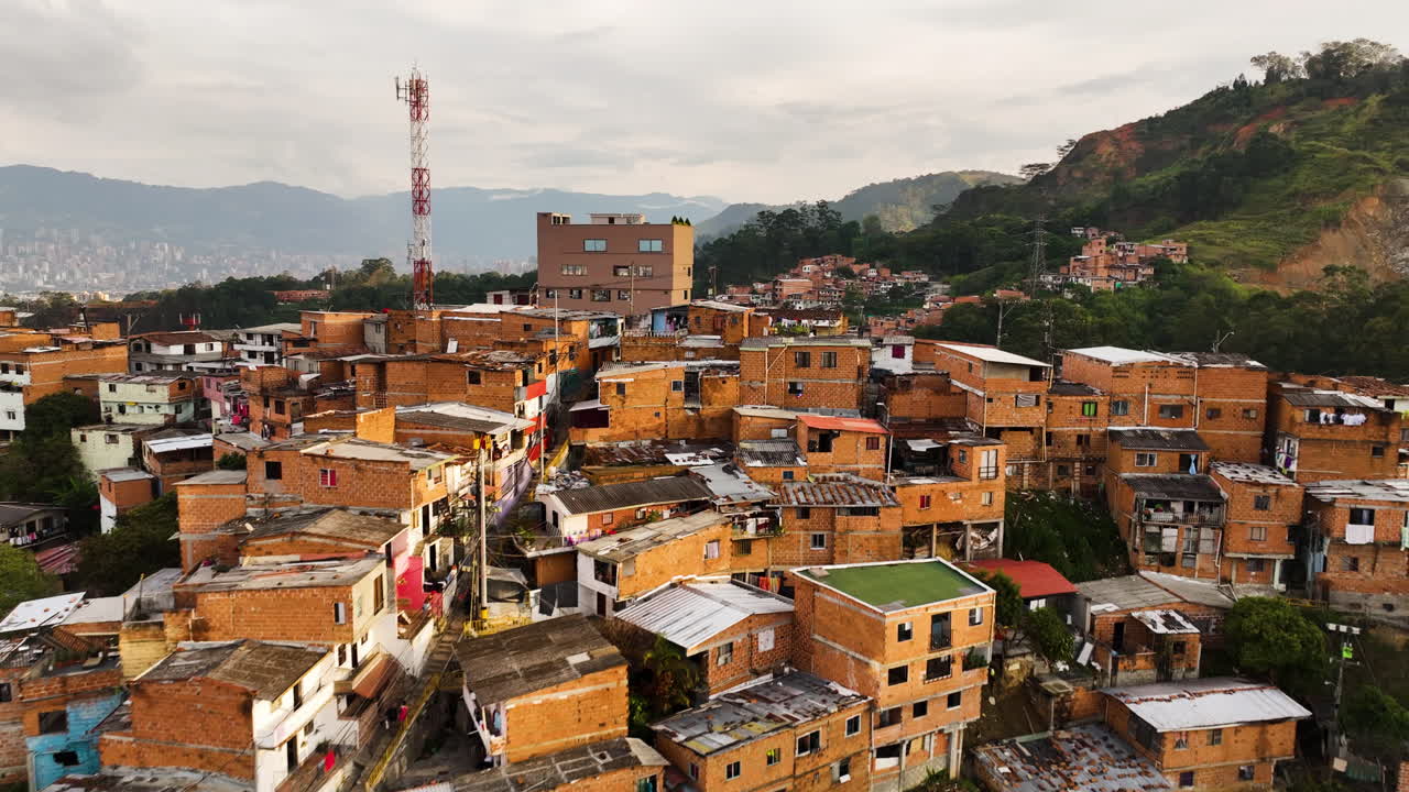 Flying over old favela homes of Comuna 13, sunny Medell&iacute;n, Colombia - Aerial view