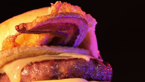 savory burger with neon lightning and black background