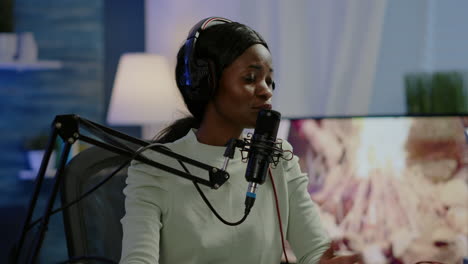 African-woman-host-of-online-show-talking-into-microphone