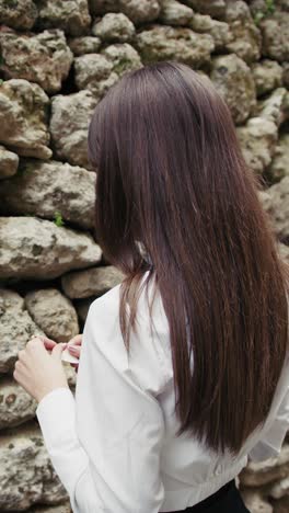 woman reading a prayer in front of the sacred old wall