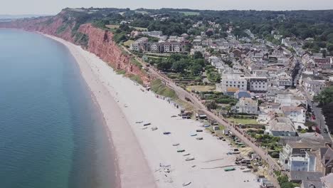 Aerial-movement-toward-beautiful-red-cliffs-along-the-Jurassic-Coast-in-Budleigh-Salterton,-STATIC-CROP