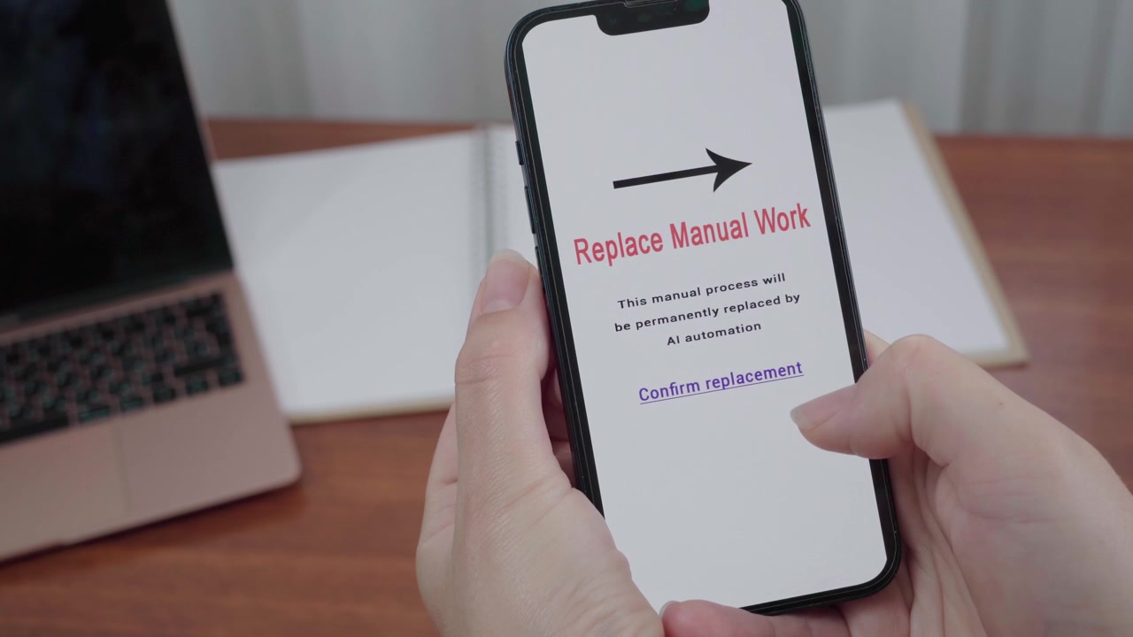Hands hold a smartphone displaying an AI automation message asking to replace manual work with a confirm replacement link.