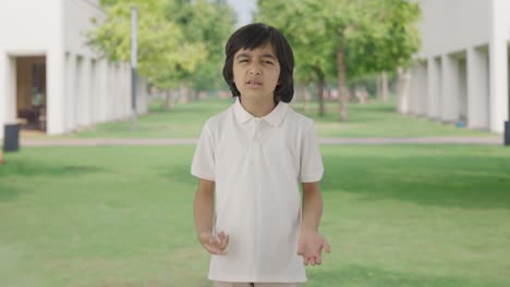 confused indian boy asking what question in park