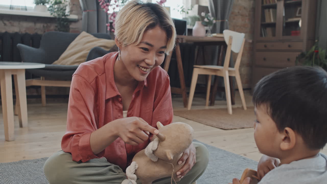 Asian Mother and Son Playing in Living Room
