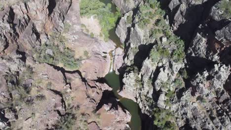 Arizona-drone-video-of-waterfall-creek-top-down-shot-with-water-and-cactus-near-a-box-canyon