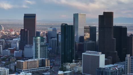downtown denver cityscape city tall skyscraper buildings aerial drone colorado spring summer afternoon sunset mountains range landscape city park rhino pan clouds sunny panorama upwards motion