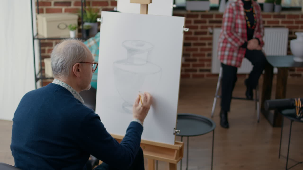Senior man attending art class lesson to develop new skills