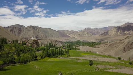 flying over village in tibetan himalayas - ladakh india drone shot