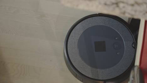 a robotic vacuum tidying up the floor - close up