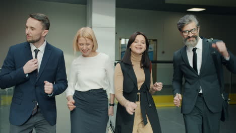 Business Team Celebrating in Office Corridor