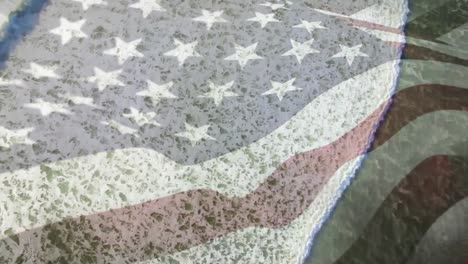 digital composition of waving us flag against aerial view of the sea waves