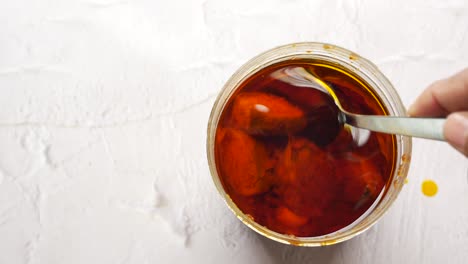 homemade mango pickle in a glass jar on table