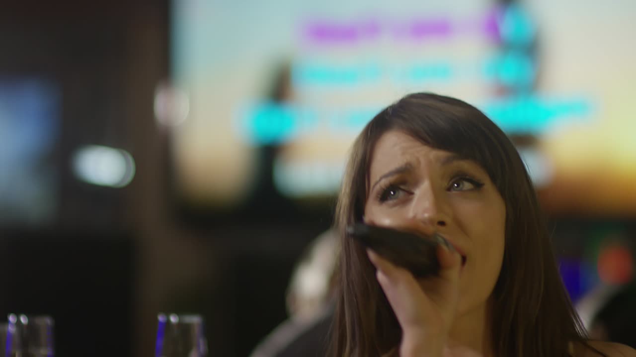 Joyous Woman Using Microphone when Singing