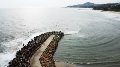 aerial, tetrapod seawall structures protecting coast from strong waves in mui ne, vietnam