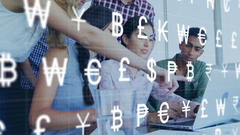 Animation-of-currency-symbols-over-diverse-colleagues-discussing-together-over-a-laptop-at-office