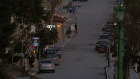 In-Nea-Kallikratia-Greece-seen-quiet-street-with-parked-cars-and-trees