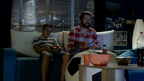 man and boy playing videogame together