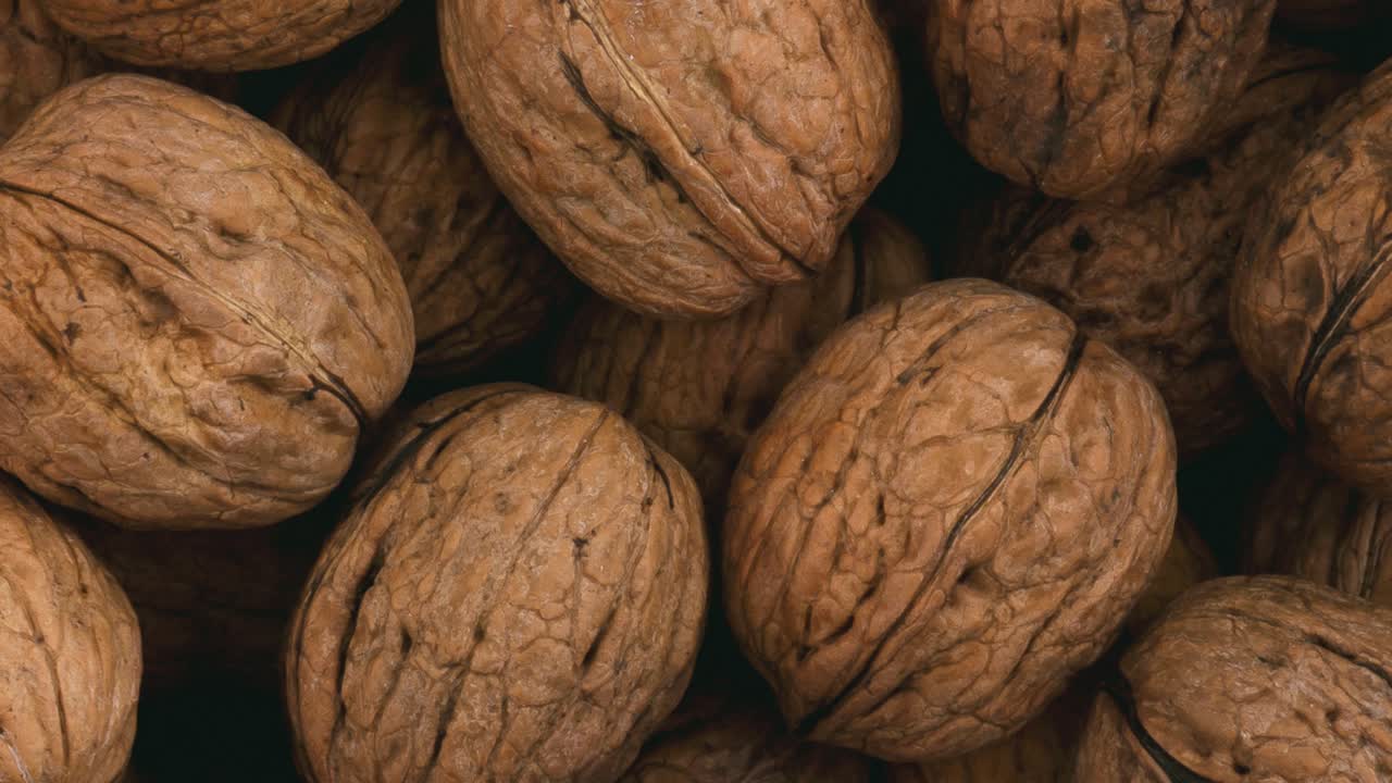 Rotating pile of whole walnuts.