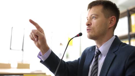 man giving a speech or presentation with a microphone