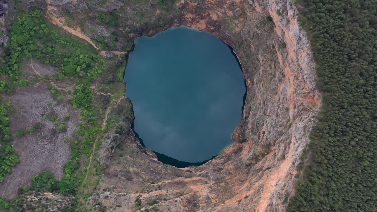 Fascinating karst blue lake crater Imotski Croatia aerial rotating