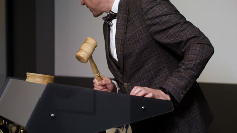 Man in elegant suit with gavel