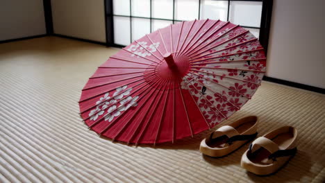 traditional japanese umbrella and geta on tatami mat