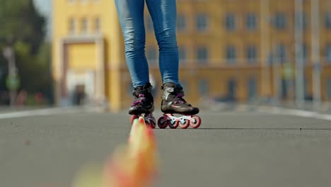 close-up, roller skating feet circling criss cross cones. inline skates skate quickly between the cones. 4k, 10bit, prores