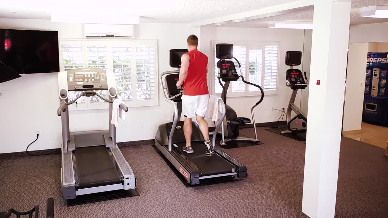 Man Running on Treadmill in Gym