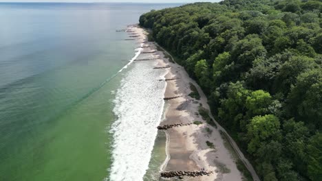 aerial pan up of waves coming to shore, aarhus, denmark