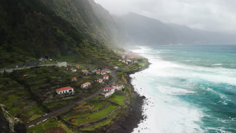 Sao-Vicente-seashore-mountainvillage,-establishment-shot-by-drone-overview,-Madeira-aerial-view