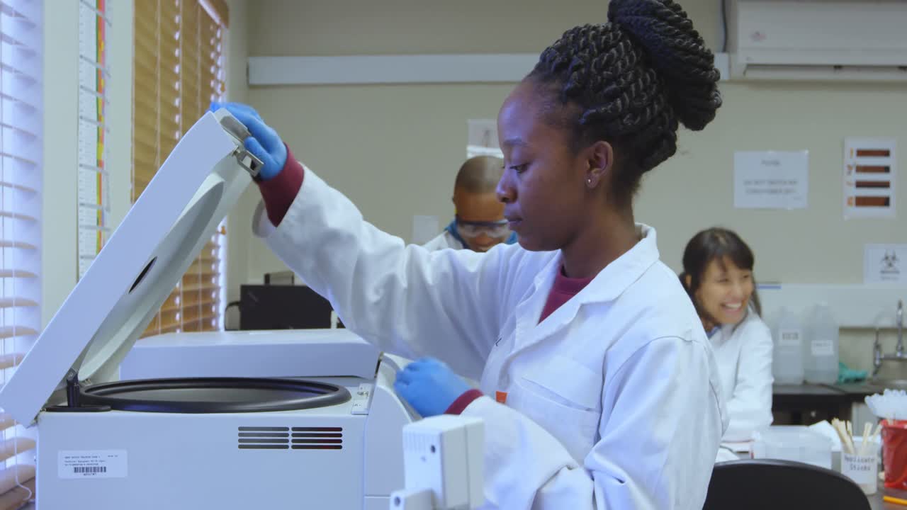 Laboratory technician using refrigerated centrifuge machine 4k