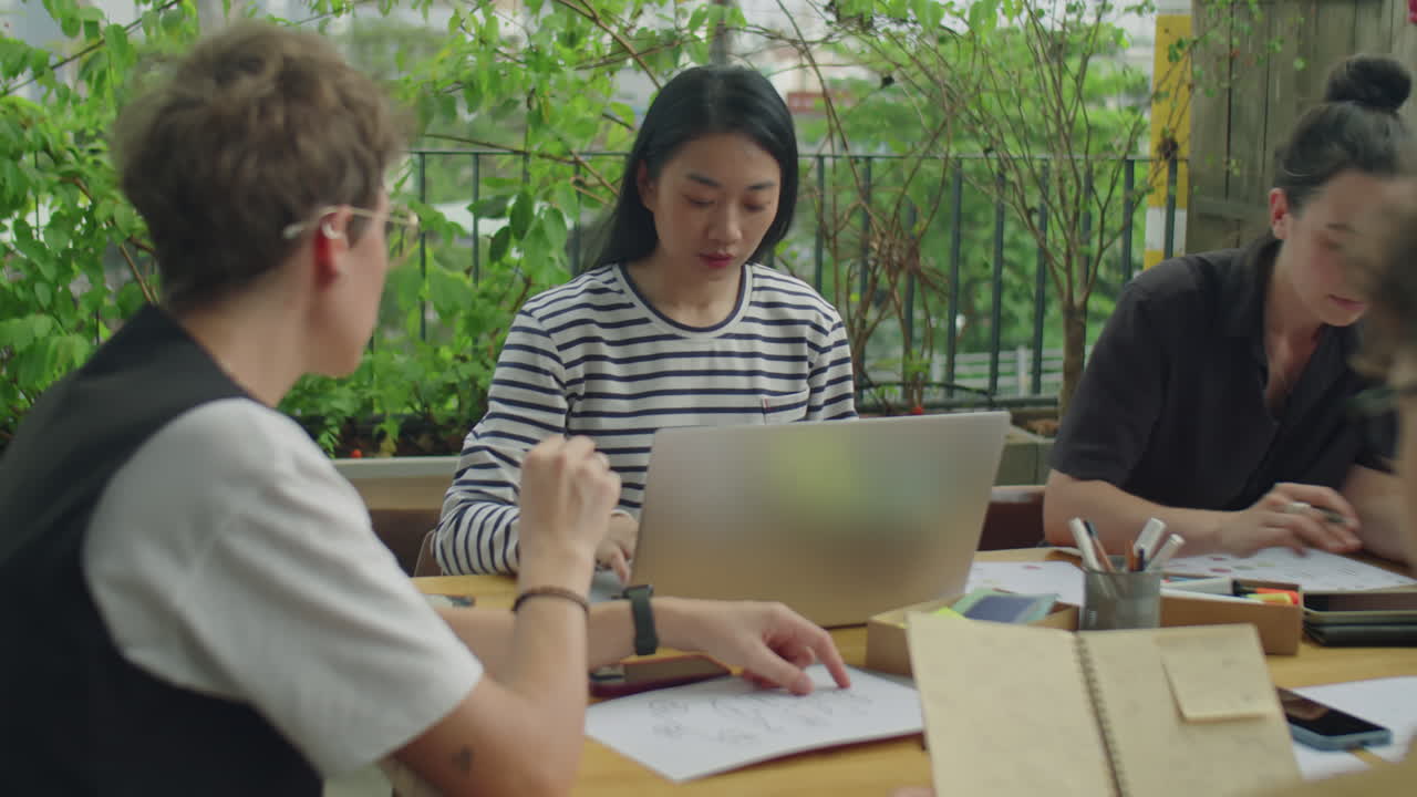 Team collaborating on a project in an outdoor workspace