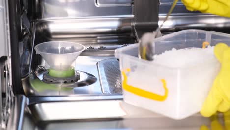 adding dishwasher salt