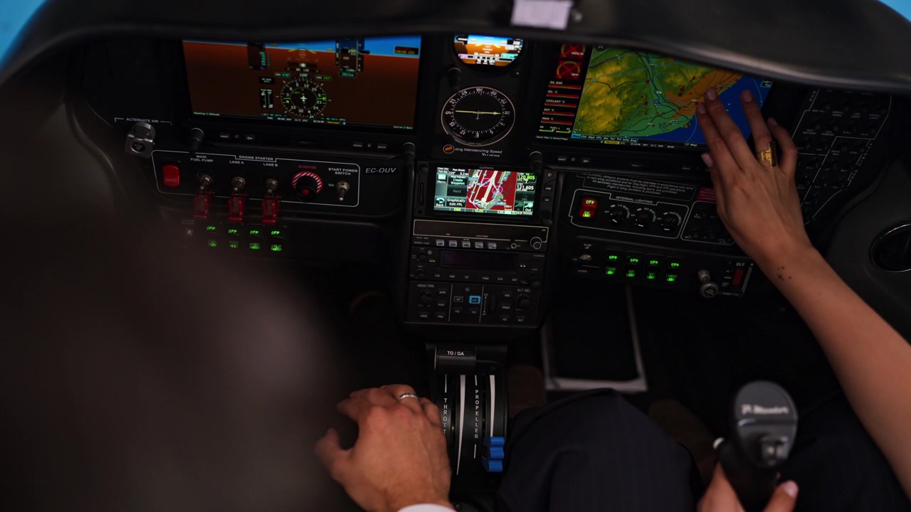 Pilots Operating Controls and Navigating in Modern Airplane Cockpit