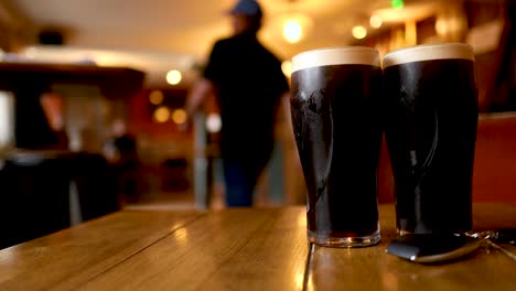 two pints on a table in a pub