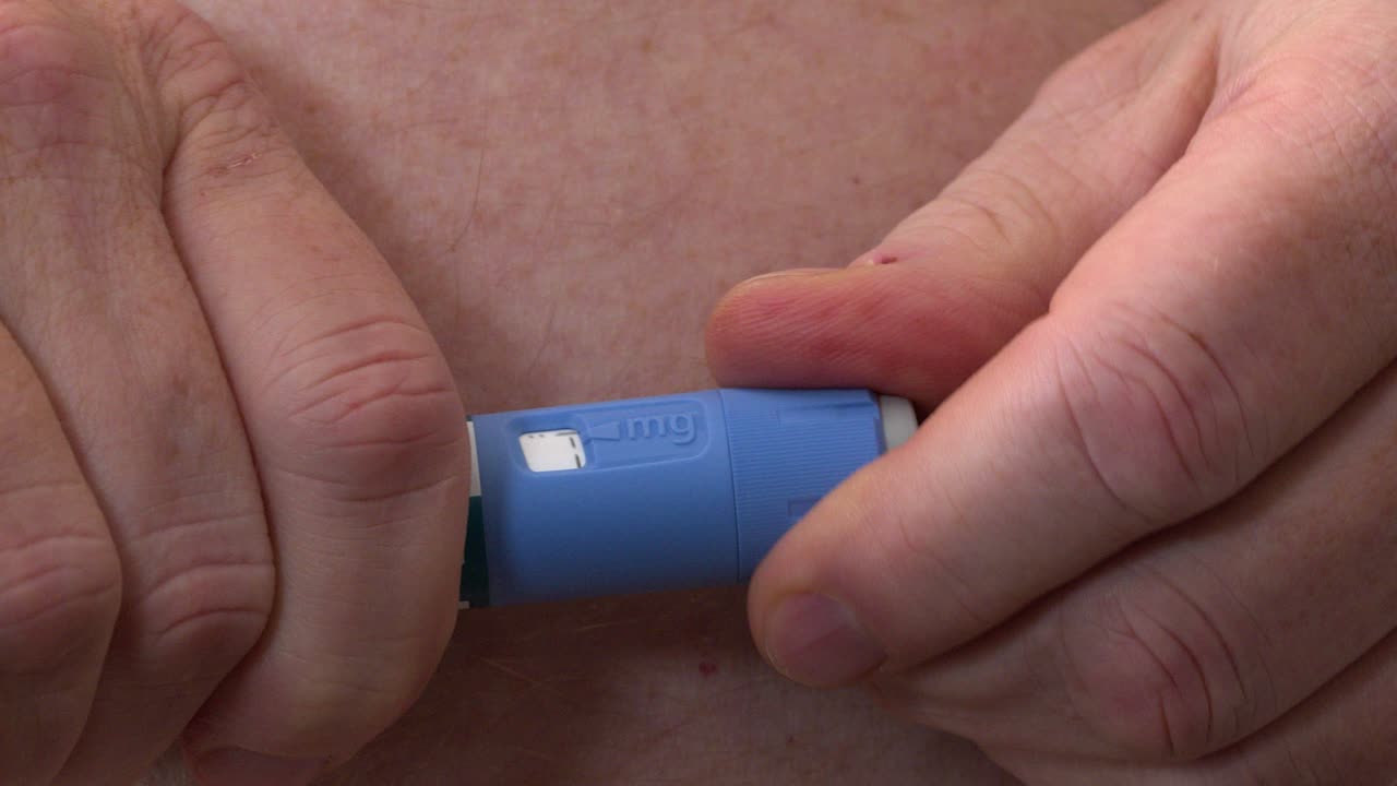 Close-up macro: Dosage knob on medication injection pen is adjusted