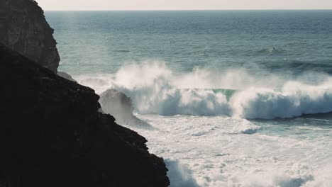 powerful waves crashing against the cliffs of nazare, portugal.