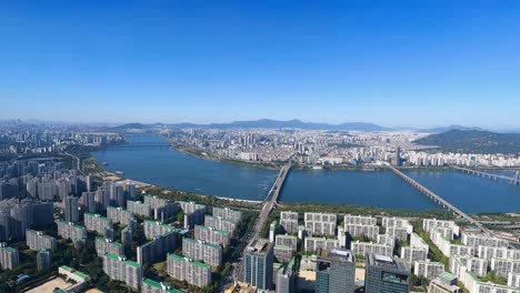 seoul city skyline view daytime with traffic on bridges over han river