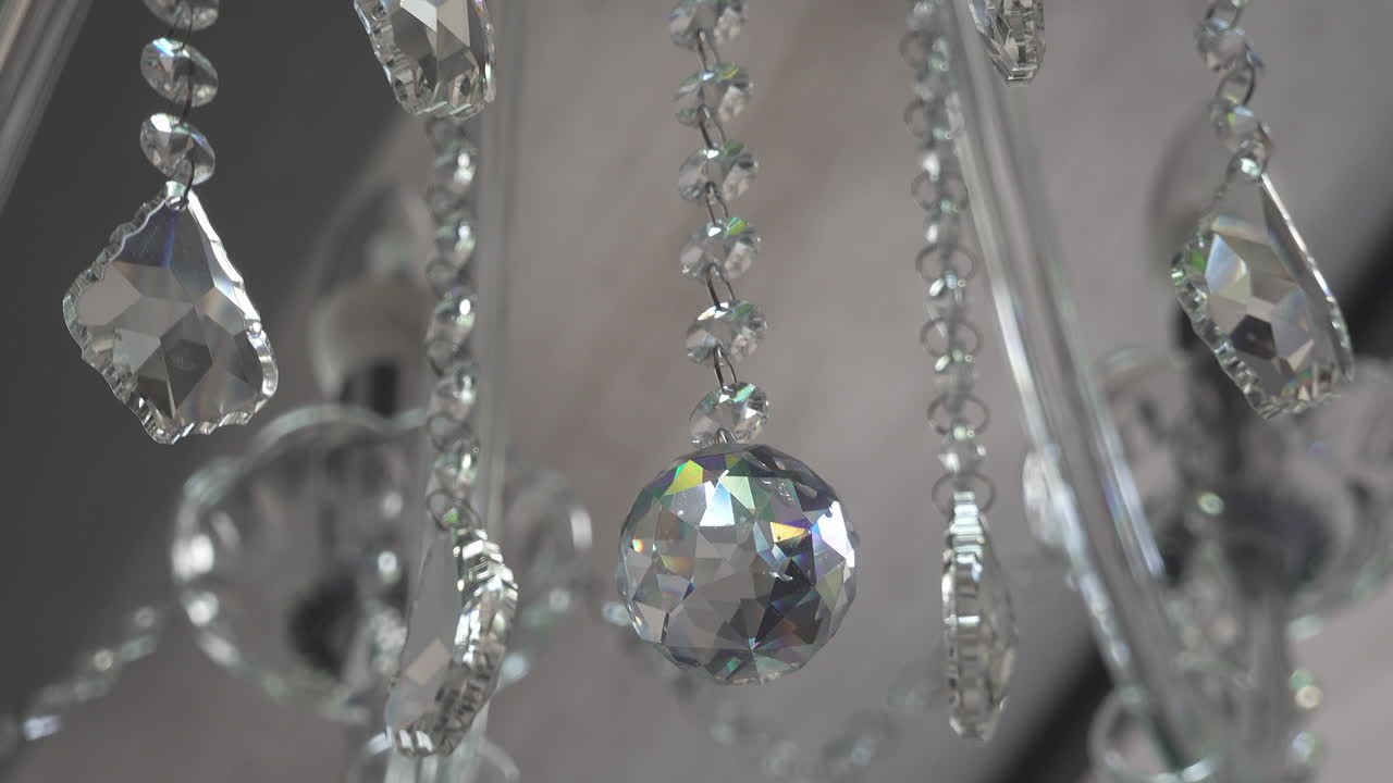 Close up of a crystal chandelier hanging on the ceiling