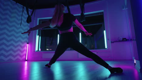 stretching-and-dancing-training-in-fitness-yoga-class-woman-is-moving-in-hammock-for-aerial-yoga