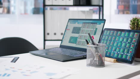 Stock-market-values-going-up-and-down-on-laptop-in-empty-office