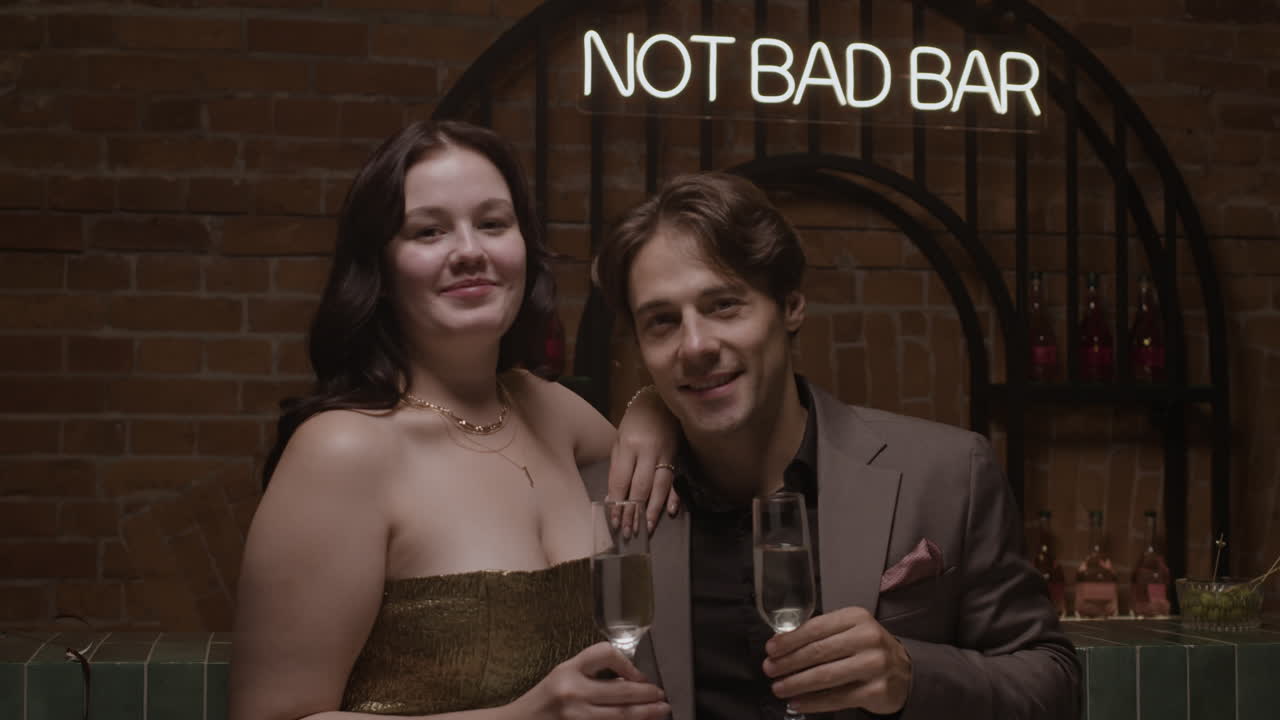 Couple celebrating with champagne at a bar
