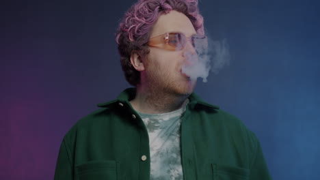 stylish man exhaling smoke